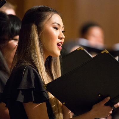 A woman singing during the 2019 Christmas Choral Concert.