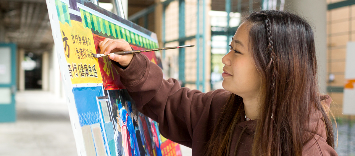 A student working on a painting outside of the Painting Studio.
