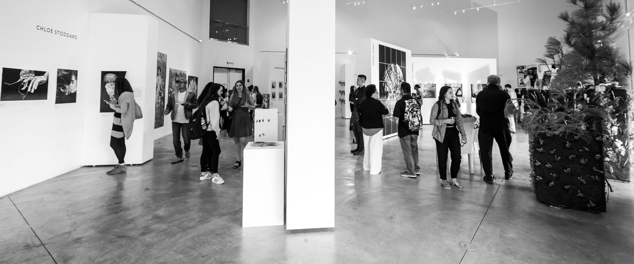 Visitors explore the student gallery at the 2018 Fine Arts Senior Exhibition.