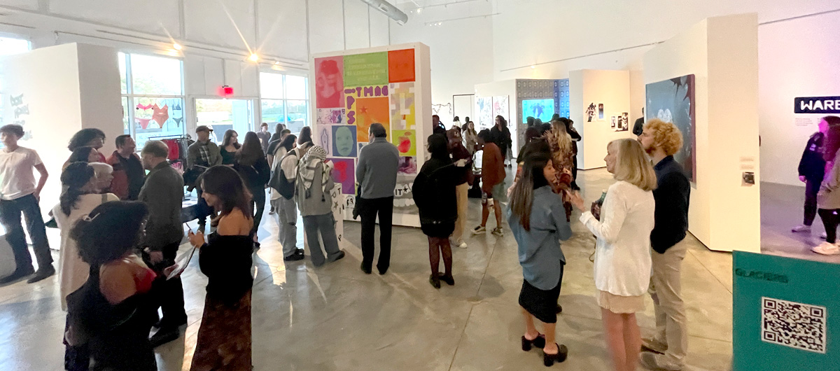 Gallery visitors mingling at the 2024 Graphic Design Senior Exhibition.