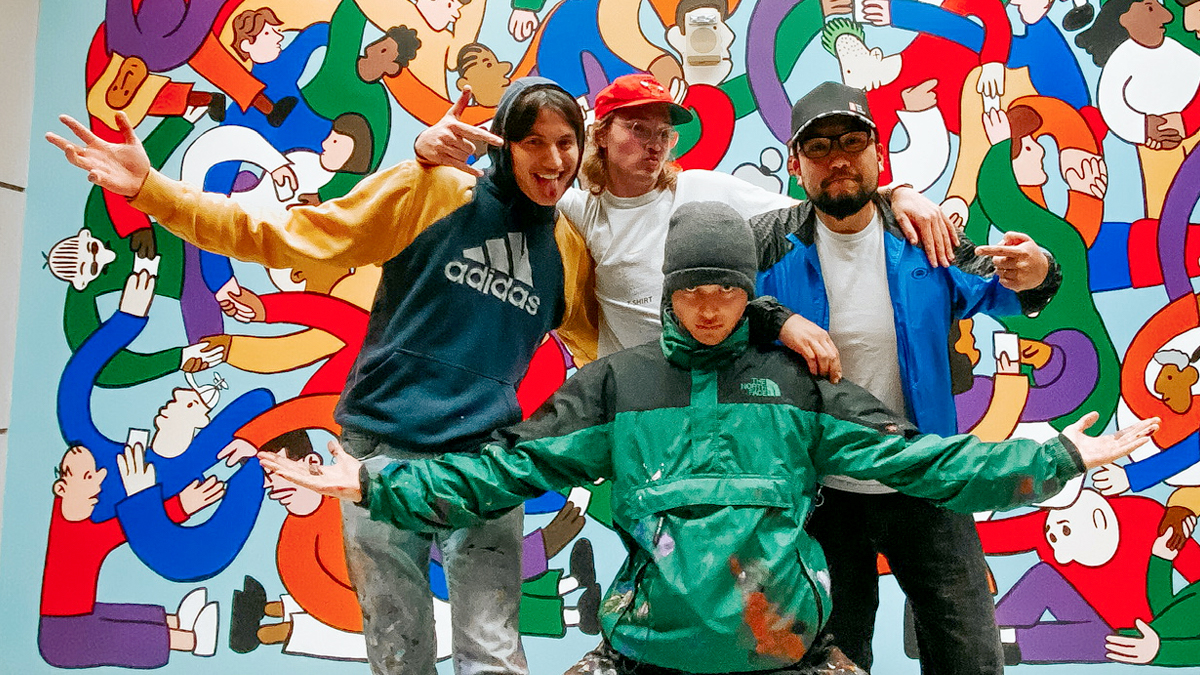 Members of Curbside (Jacob Johanson, Jack Alving, Bobby Sutton) posing for a photo with Macha Suzuki in front of their artwork.