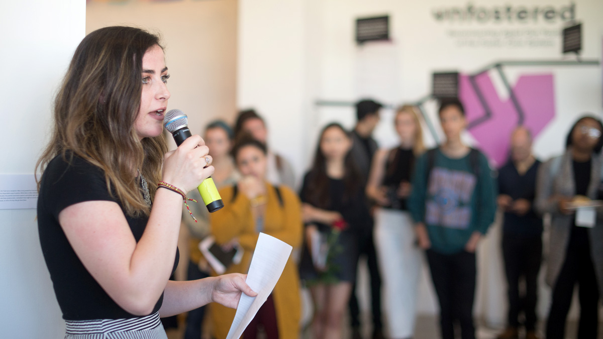 A graphic design senior presenting her work at the Graphic Design Senior Exhibition in 2018.