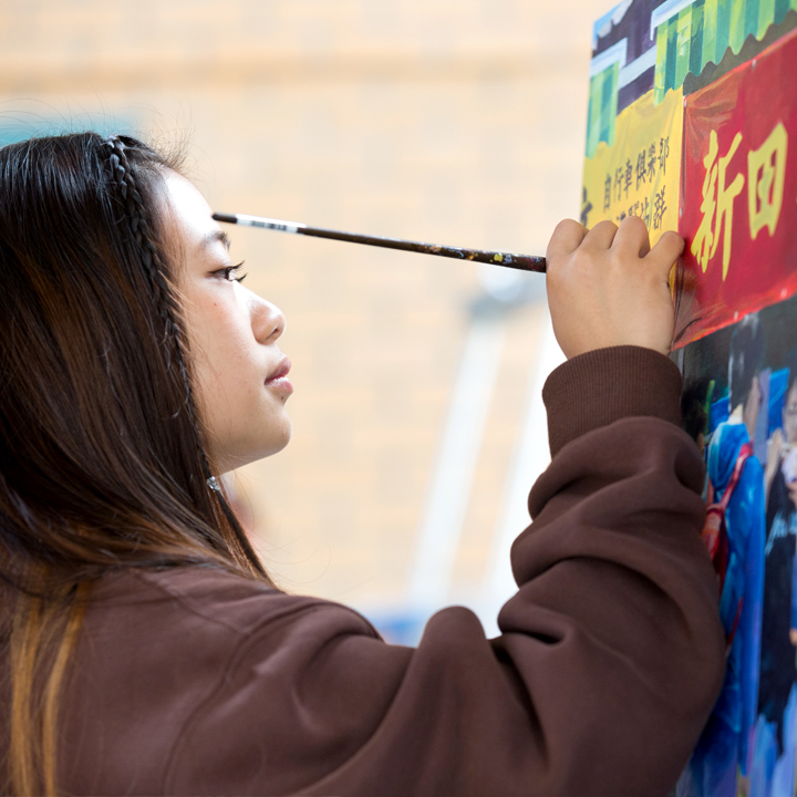 A student painting outside of the studio.
