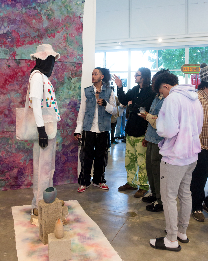 Students looking at artwork at the 2022 Fine Arts and Multimedia Arts Senior Exhibition.