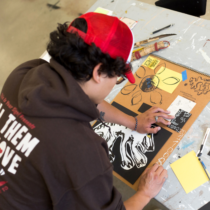 A student working on artwork in the Makerspace.