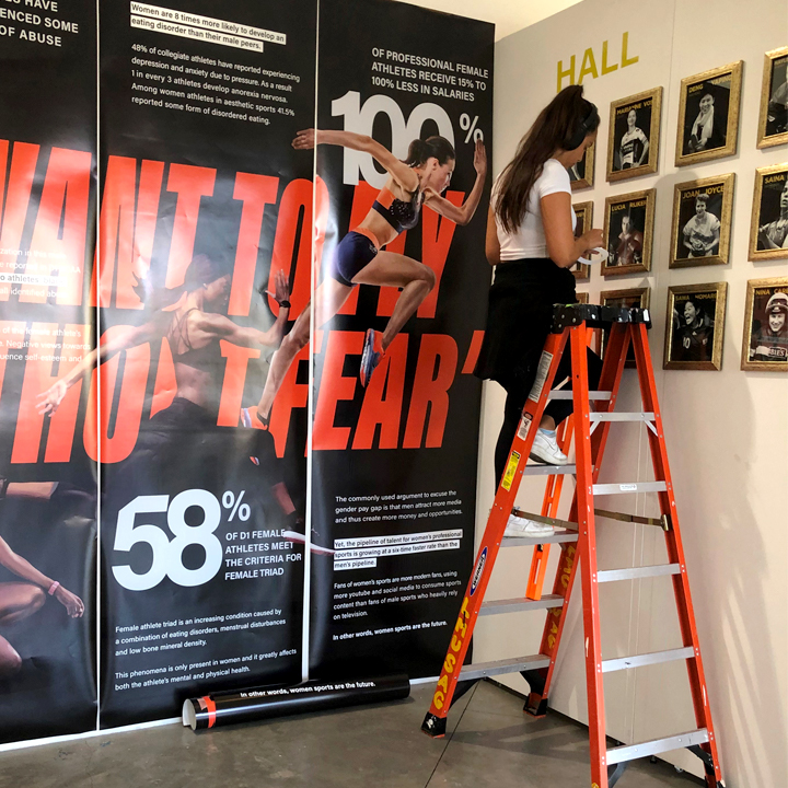 A student working on her exhibit in the TPK Student Gallery.