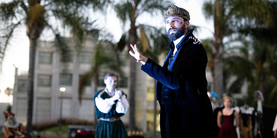 A man acts in an outdoor Shakespeare production