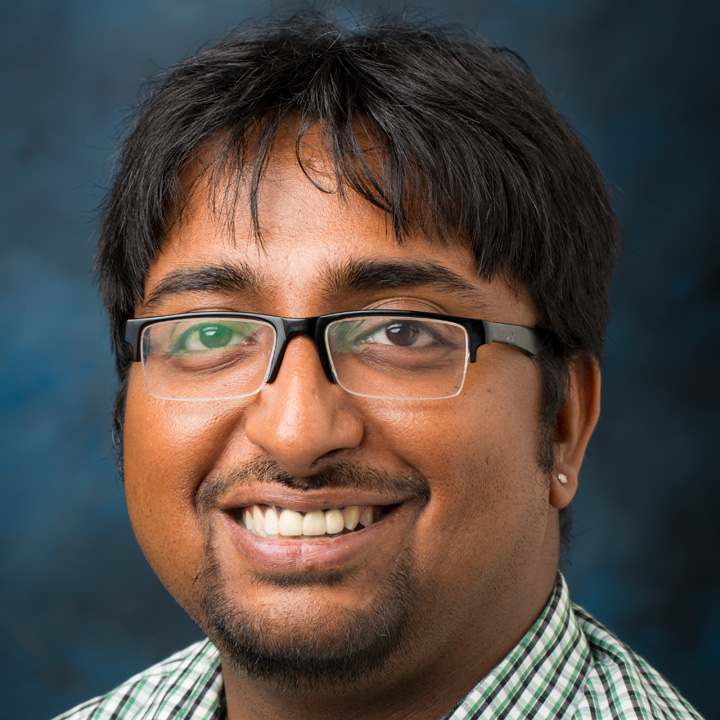 Photo of Arnab Banerji wearing a green-colored shirt, with glasses.