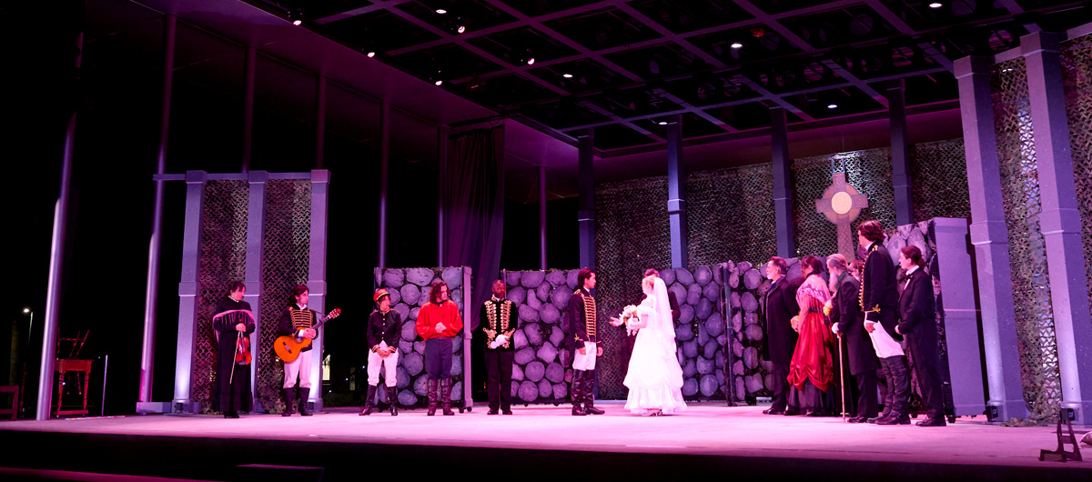 The cast of Much Ado About Nothing performing onstage.