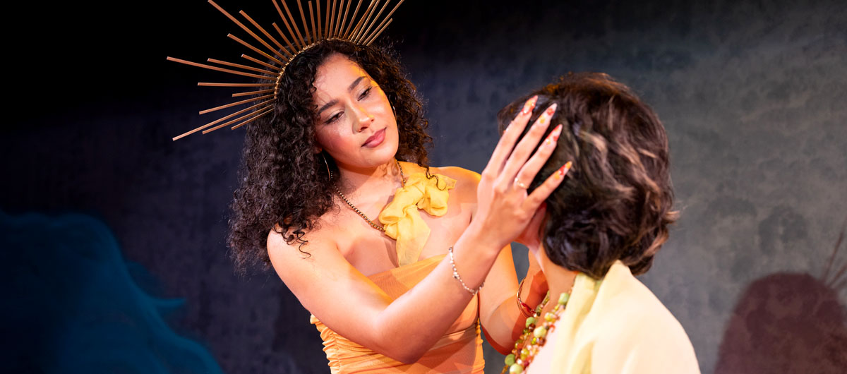 A woman in yellow looking at someone's head.