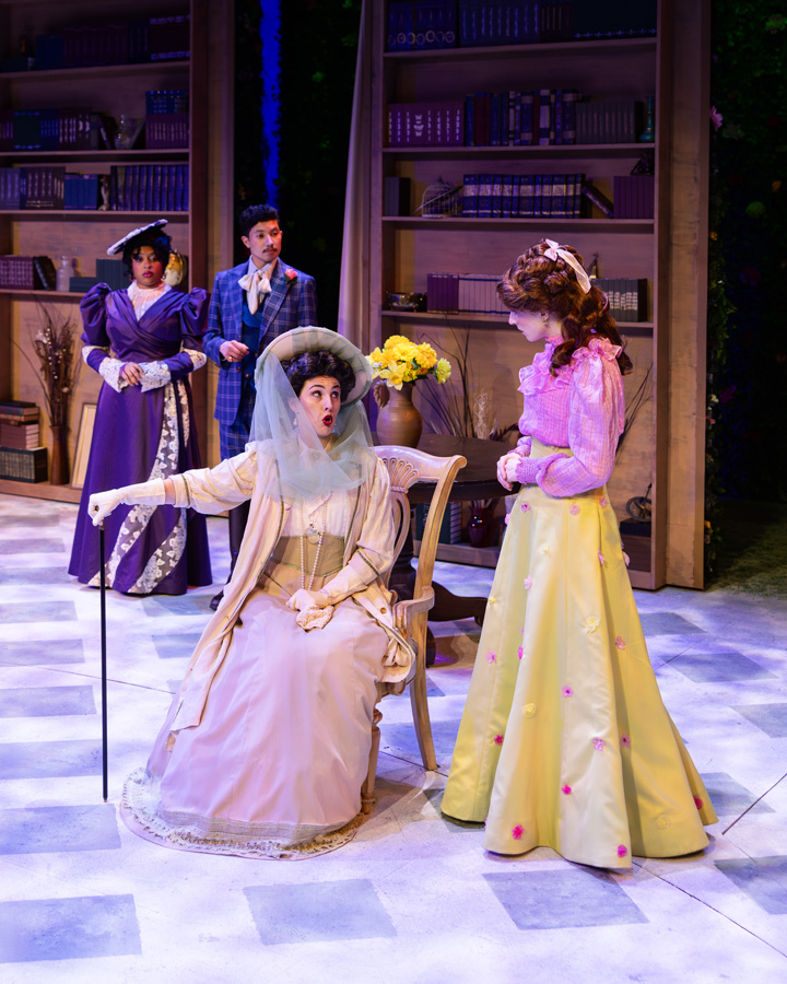 Two women in the foreground talking to each other while two other people look on.
