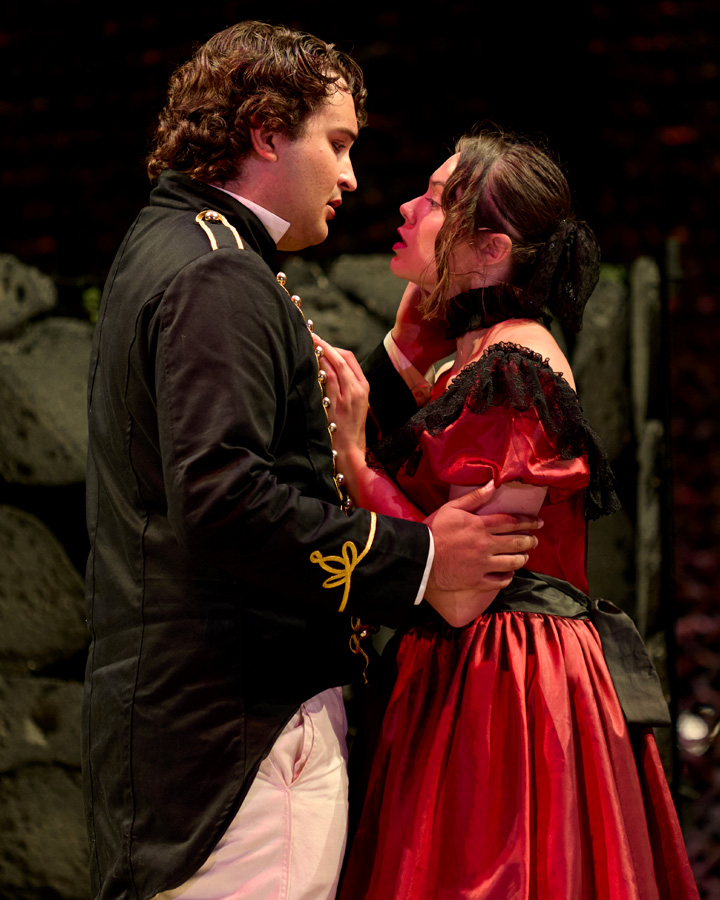 A couple embraces during a scene from Much Ado About Nothing.