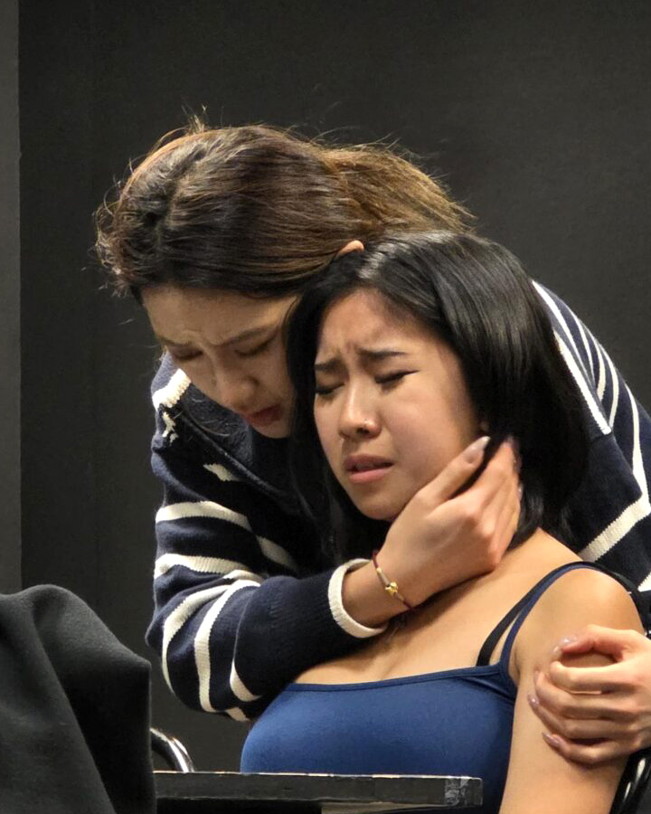 Two women embracing during an important conversation.