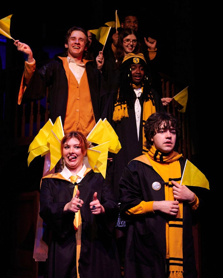 A group of people with yellow flags, gathered on a staircase.