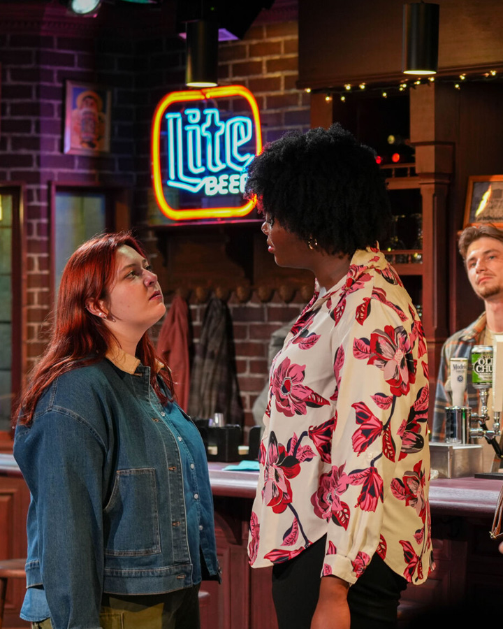Two women having a serious conversation at a bar.