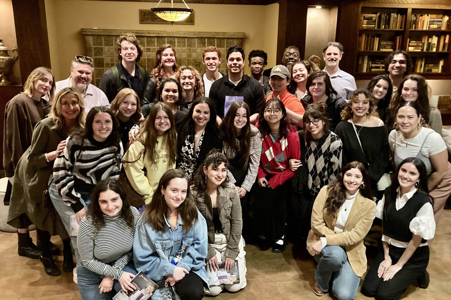 A group of students posing for a photo with Gloria Calderón Kellett.