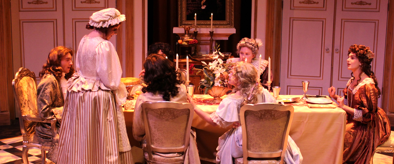 Characters seated at a table in Tartuffe 