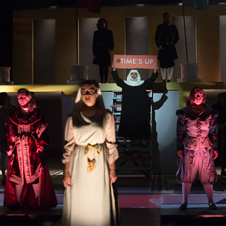 Students performing onstage in a production of Measure for Measure.