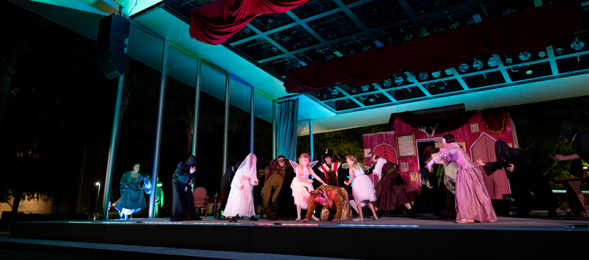 The cast of The Merry Wives of Windsor performing onstage.