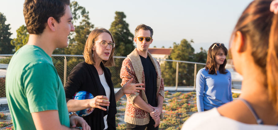 A group of MFAPP students listening to the professor.