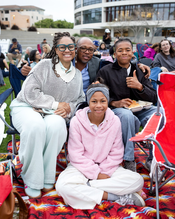 A family poses for a photo before the start of The Comedy of Errors.