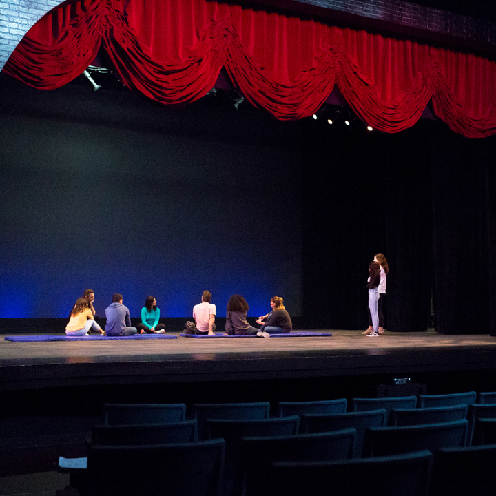 A group of MFAPP students meet onstage inside Strub Theatre.