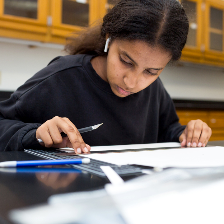 A student works on an assignment for a scenic design class.