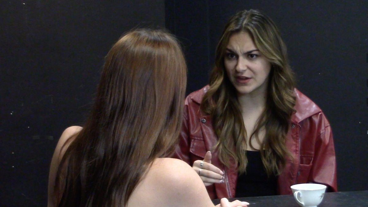 Rachel Sullivan talking to a woman at a table.