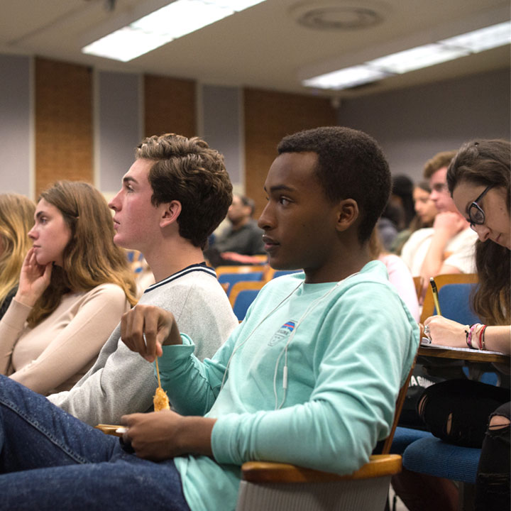 Students paying attention to a presentation in a lecture hall