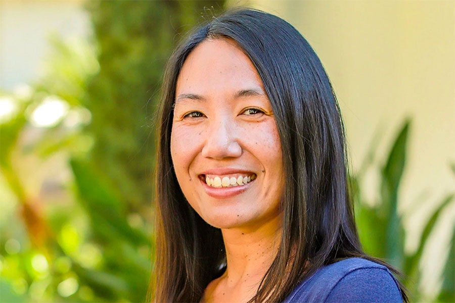Photo of Melody Rodari with plants in the background.
